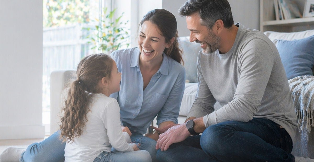 Happy parents spending time with daughter.