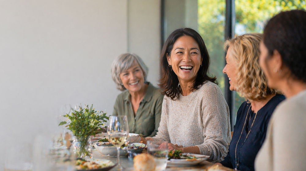woman laughing at lunch with friends