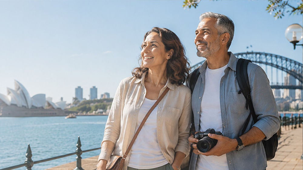 A middle-aged couple stands by a sunny waterfront, enjoying a day of sightseeing.
